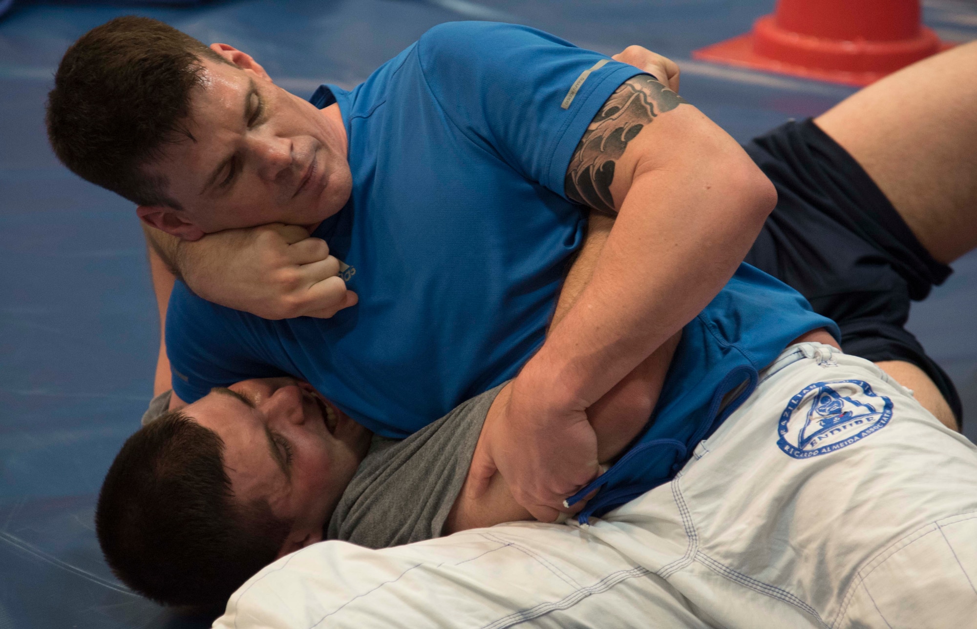 U.S. Air Force Maj. Zane Holland, the logistics flight commander of the 35th Medical Group, and Senior Airman Patrick Moore, a medical technician with the 35th Surgical Squadron, spar during a Brazilian jiu-jitsu session at Misawa Air Base, Japan, Feb. 17, 2016. The martial art of jiu-jitsu teaches individuals to defend themselves by using leverage and technique. (U.S. Air Force photo by Airman 1st Class Jordyn Fetter) 