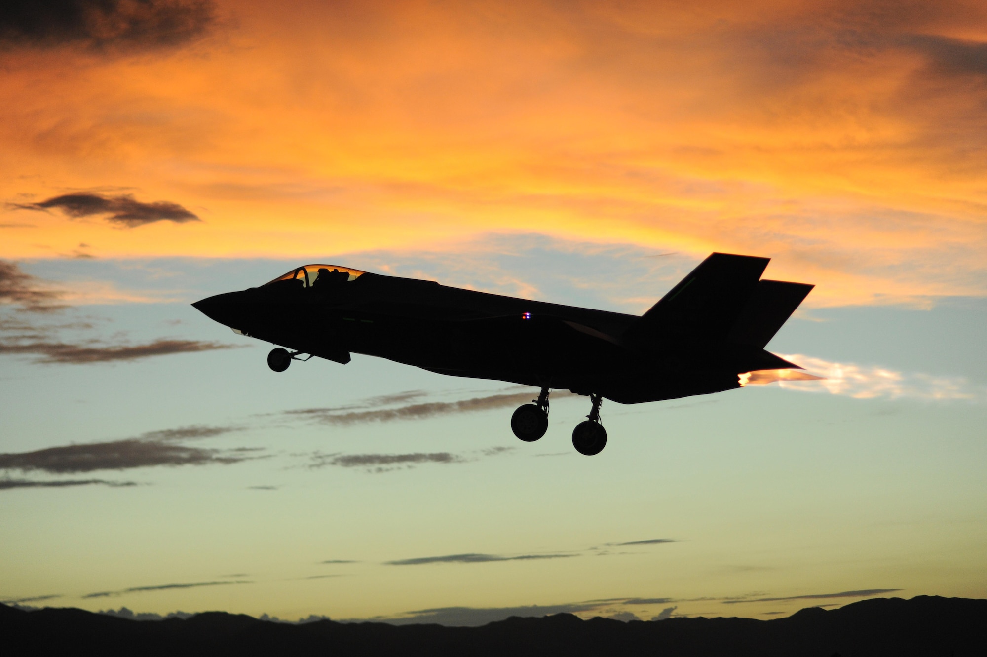 An F-35 Lightning II assigned to the 61st Fighter Squadron at Luke Air Force Base, Ariz., takes off as the sun sets. Corrosion testing of the F135 engine, the afterburning turbofan developed for the F-35 Lighting II, is undergoing testing at AEDC to see how it performs in the corrosive sea-air environment. (U.S. Air Force photo/Staff Sgt. Staci Miller)