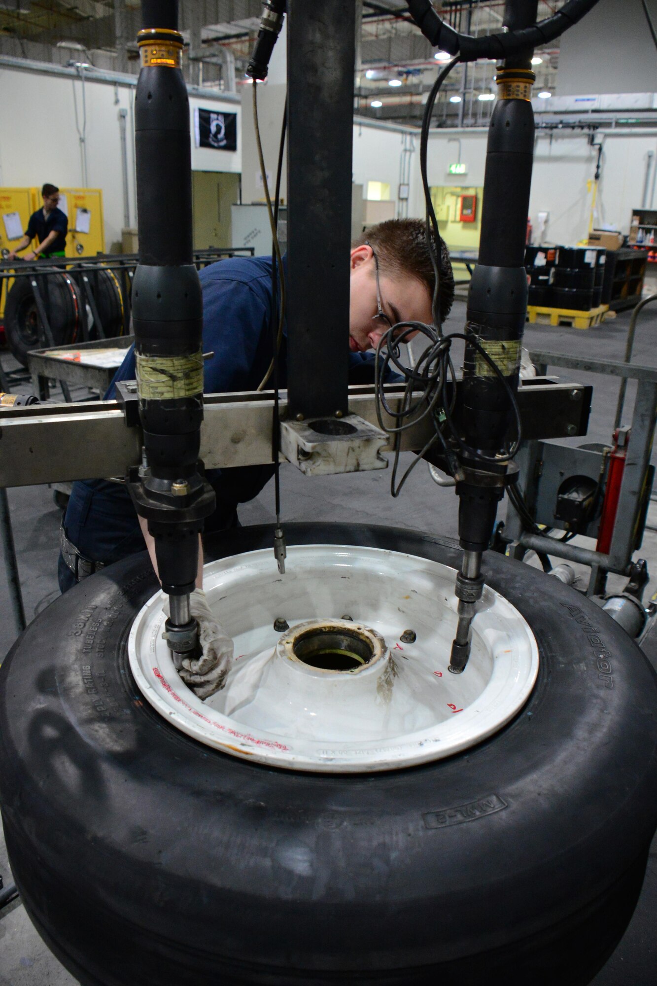 Airman 1st Class Bobbie Price III, 379th Expeditionary Maintenance Squadron aerospace maintenance journeyman, from League City, Texas, uses an automatic torque machine to remove the bolts holding a wheel together at Al Udeid Air Base, Qatar Feb. 16. The machine is programmed to quickly remove the bolts of any U.S. Air Force aircraft at AUAB. (U.S. Air Force photo by Tech. Sgt. James Hodgman/Released)