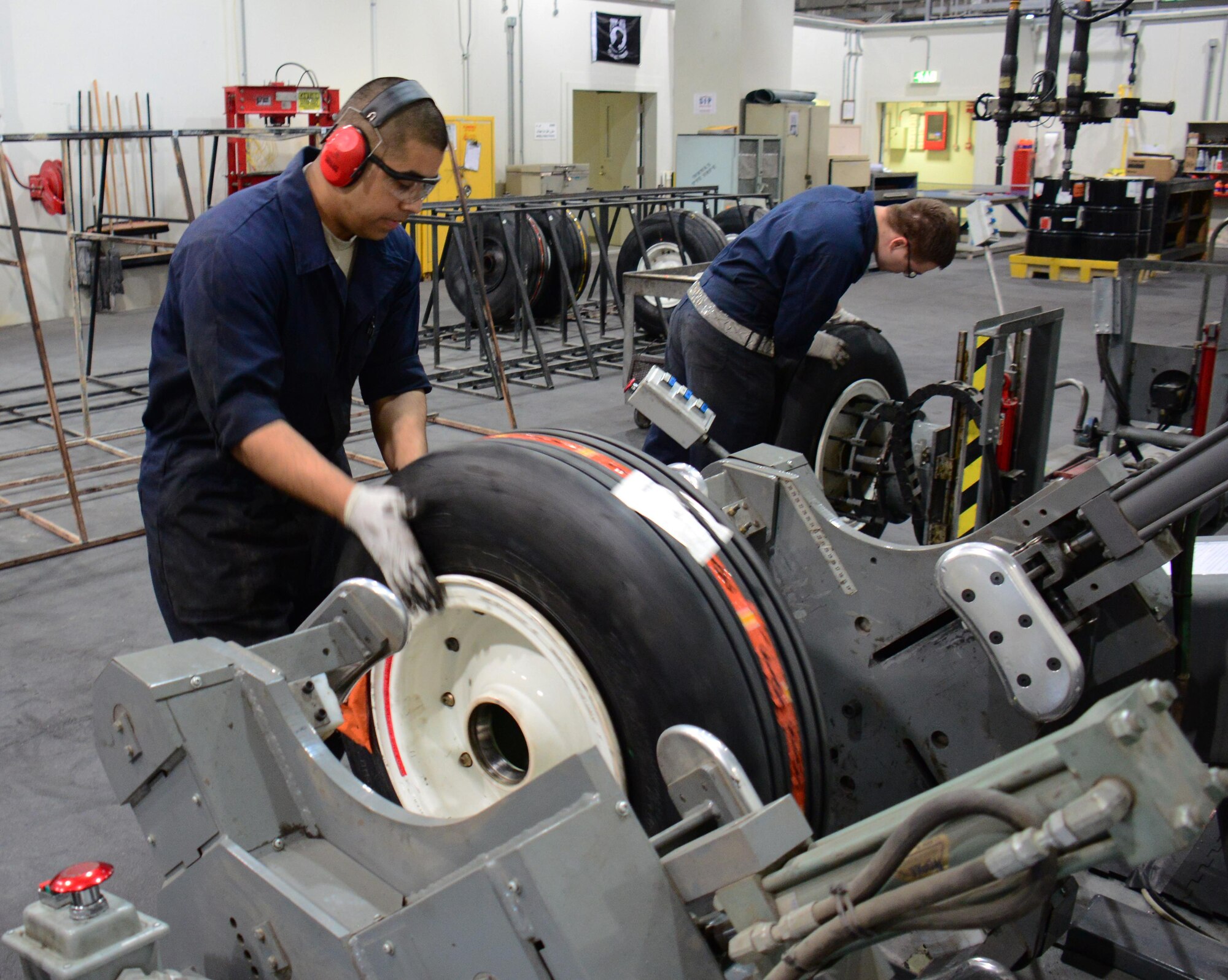 Staff Sgt. Abraham Ponce (Left), 379th Expeditionary Maintenance Squadron aerospace maintenance craftsman, from Odessa, Texas, and Airman 1st Class Bobbie Price III (Right), 379th Expeditionary Maintenance Squadron aerospace maintenance journeyman, from League City, Texas, work to repair two wheels at Al Udeid Air Base, Qatar Feb. 16. The 379 EMXS wheel and tire shop was the most productive in the U.S. Air Force in 2015. (U.S. Air Force photo by Tech. Sgt. James Hodgman)