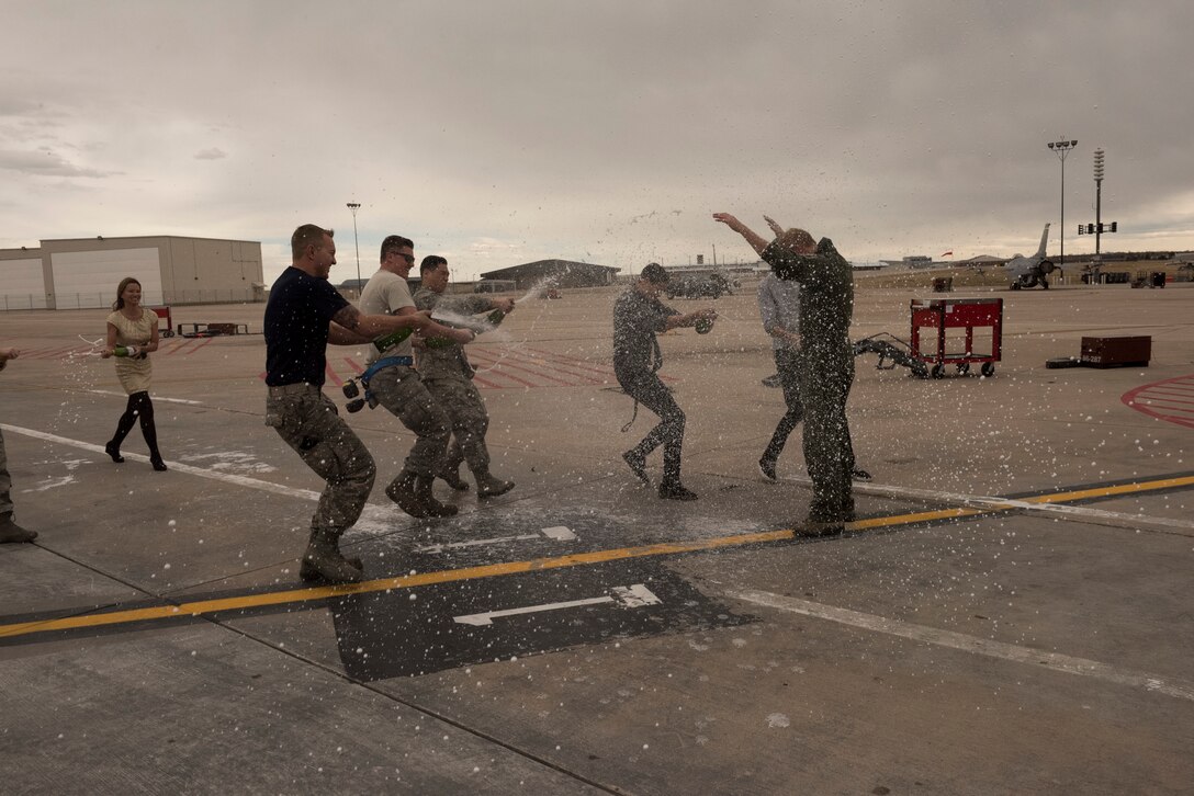 Colorado Air National Guard Col. Brian P. Patterson, commander, 140th Maintenance Group, receives a traditional champagne spraying after completing his final flight, Mar. 6, 2016, Buckley Air Force Base, Aurora, Colo. Patterson is retiring after 31 years of service in the United States Air Force and Colorado Air National Guard. (U.S. Air National Guard photo by Staff Sgt. Michelle Y. Alvarez-Rea)