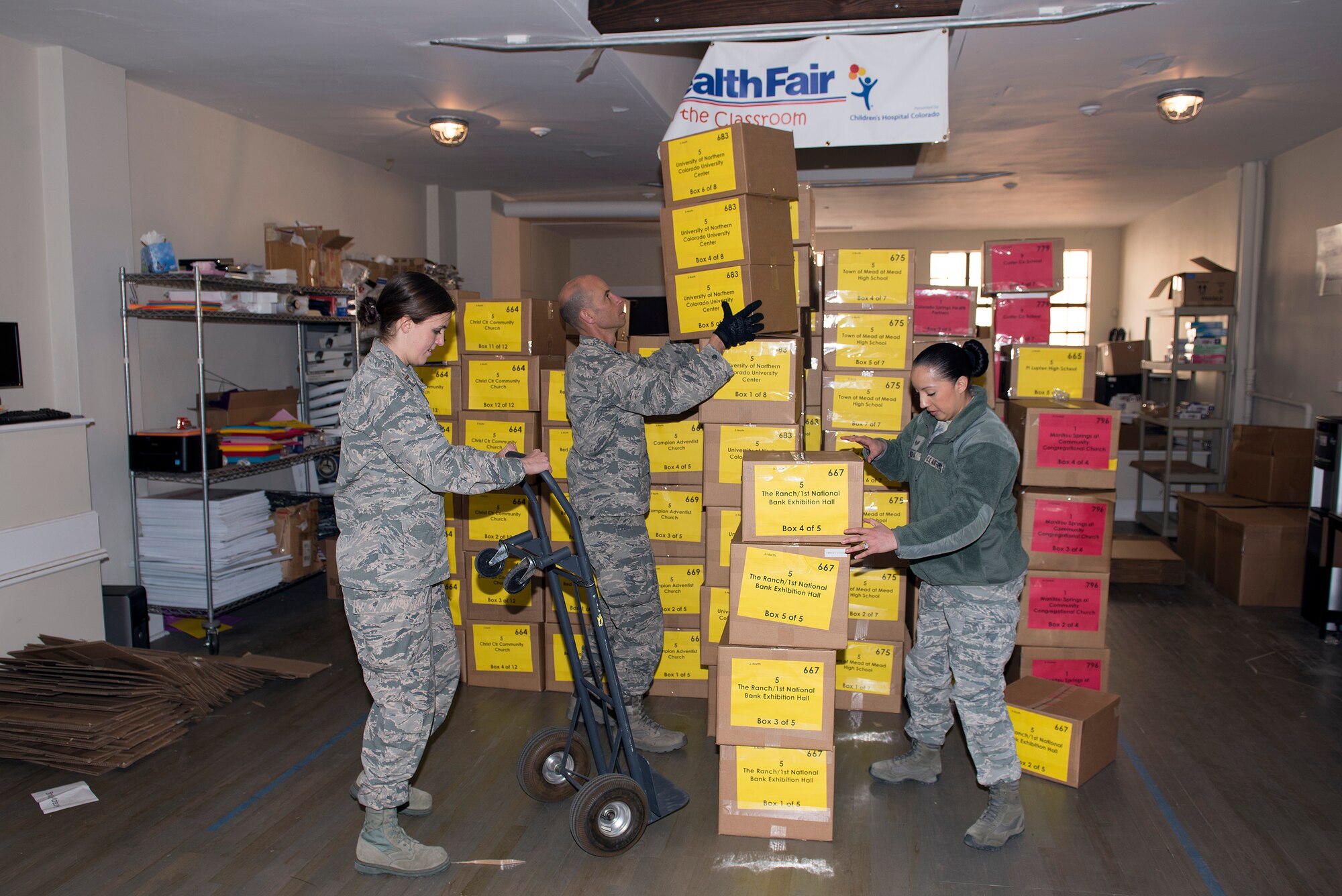 Members of the 233d Space Group, Colorado Air National Guard, Greeley, Colo. help load boxes of medical supplies onto one of their vehicles in order to help distribute them to all corners of Colorado for the annual 9Health Fair. This Innovative Readiness Training program not only provides support to the community, it also helps members of the 233 SG accomplish mandatory training time driving the semi-trucks. (U.S. Air National Guard photo by Senior Master Sgt. John Rohrer)