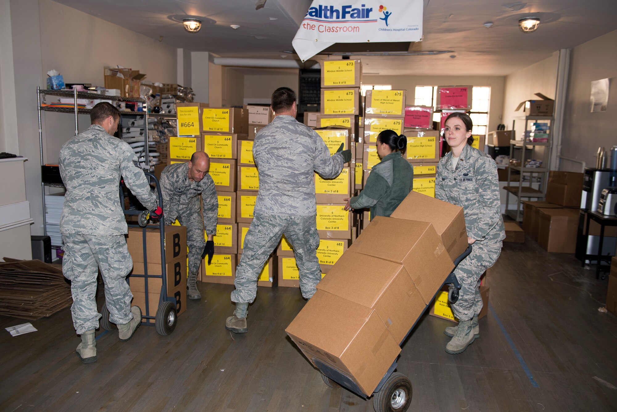 Members of the 233d Space Group, Colorado Air National Guard, Greeley, Colo. help load boxes of medical supplies onto one of their vehicles in order to help distribute them to all corners of Colorado for the annual 9Health Fair. This Innovative Readiness Training program not only provides support to the community, it also helps members of the 233 SG accomplish mandatory training time driving the semi-trucks. (U.S. Air National Guard photo by Senior Master Sgt. John Rohrer)