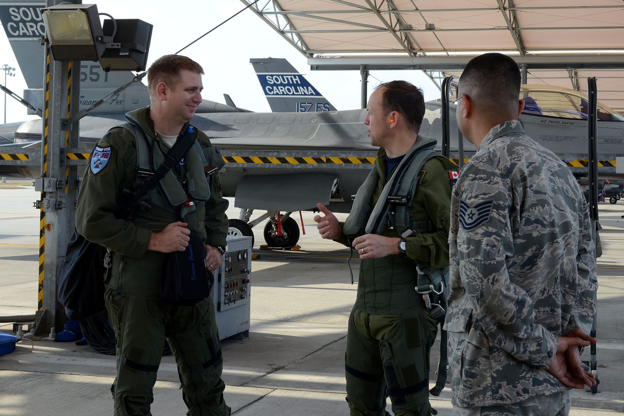 Canadian Forces Brig. Gen. Alain Pelletier, deputy commander Continental United States NORAD Region (CONR), receives and orientation flight on an F-16 Fighting Falcon fighter jet accompanied by Lt. Col. Ian Toogood, commander of the 169th Aerospace Control Alert Squadron, during his visit to the South Carolina Air National Guard's 169th Fighter Wing at McEntire Joint National Guard Station, Mar. 1, 2016. During his visit, Brig. Gen. Pelletier spoke to wing leadership about its homeland defense mission and the relationship it has with the NORAD air component as it is tasked through CONR to ensure North American airspace control. The 169th FW has provided support for numerous CONR training and air defense events in past years. (U.S. Air National Guard photo by Senior Airman Ashleigh S. Pavelek) 