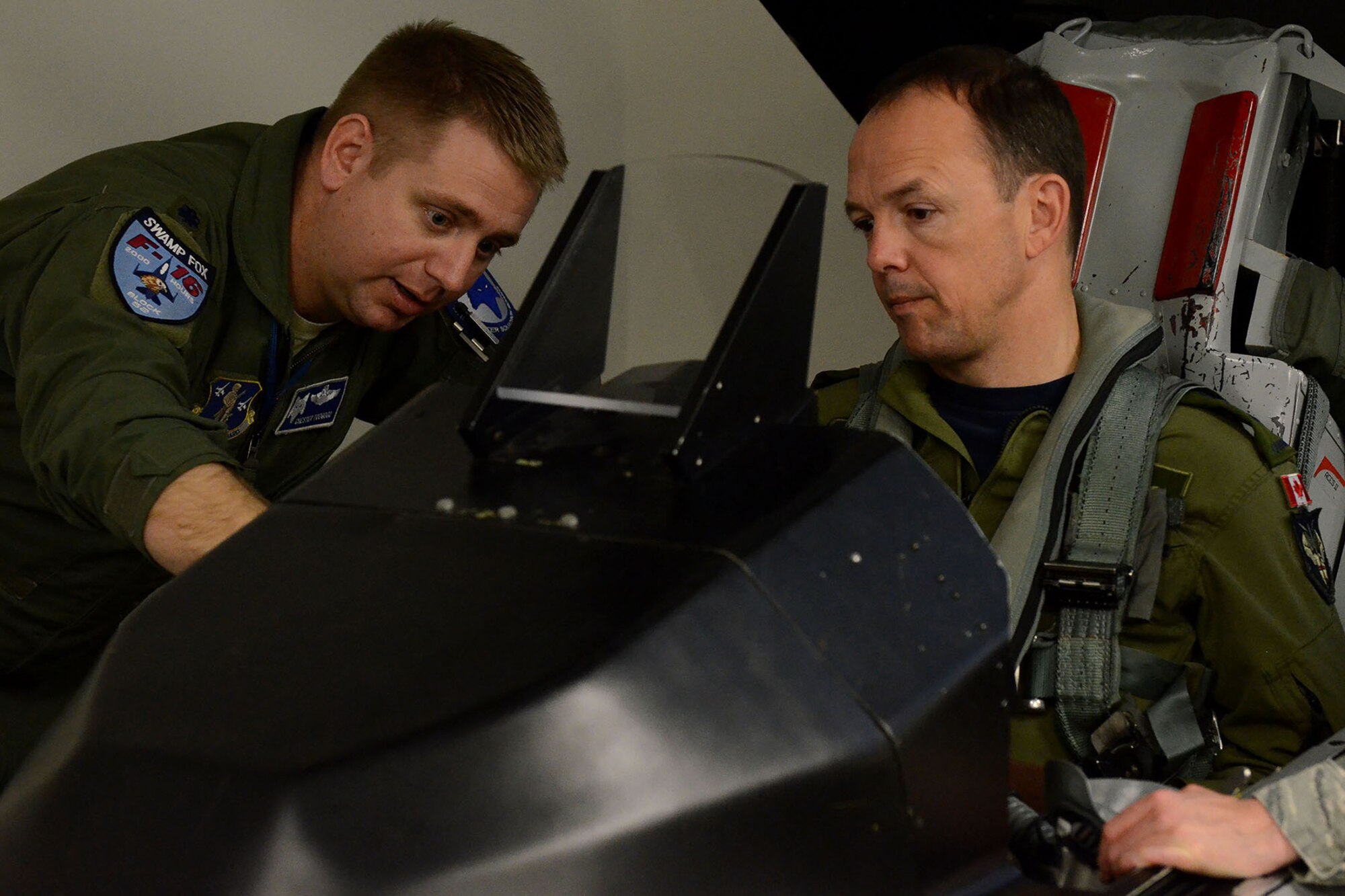 Canadian Forces Brig. Gen. Alain Pelletier, deputy commander Continental United States NORAD Region (CONR), receives and orientation flight on an F-16 Fighting Falcon fighter jet accompanied by Lt. Col. Ian Toogood, commander of the 169th Aerospace Control Alert Squadron, during his visit to the South Carolina Air National Guard's 169th Fighter Wing at McEntire Joint National Guard Station, Mar. 1, 2016. During his visit, Brig. Gen. Pelletier spoke to wing leadership about its homeland defense mission and the relationship it has with the NORAD air component as it is tasked through CONR to ensure North American airspace control. The 169th FW has provided support for numerous CONR training and air defense events in past years. (U.S. Air National Guard photo by Senior Airman Ashleigh S. Pavelek) 