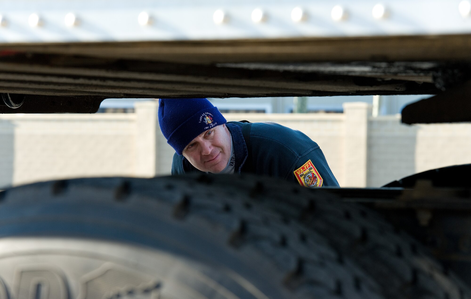 Larry McGunnigle, Fairfax County Fire and Rescue Department, Va.: Virginia Task Force 1 logistics specialist, keeps an eye on the fifth-wheel as it connects to a 48-foot trailer March 3, 2016, at the 436th Aerial Port Squadron marshalling yard on Dover Air Force Base, Del. The 48-foot trailer was weighed by itself prior to reconnecting to a Freightliner truck and was loaded onto a C-5M Super Galaxy as part of a Urban Search and Rescue Team training exercise ranging from deployment to aircraft loading. (U.S. Air Force photo/Roland Balik)