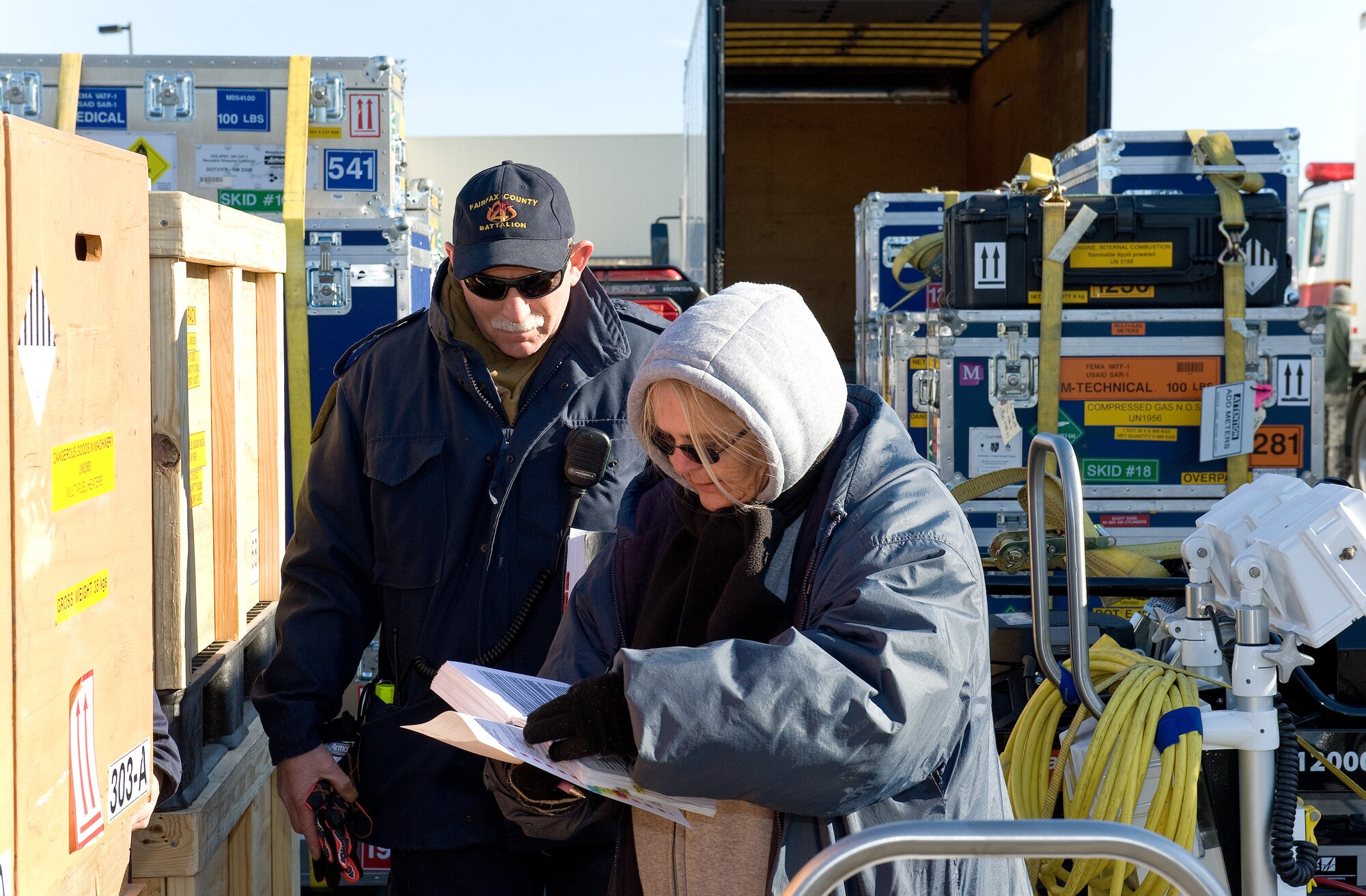 Bruce Newhaus, Fairfax County Fire and Rescue Department, Va.: Virginia Task Force 1 logistics manager, and Anna Reed, 436th Aerial Port Squadron hazardous material inspector processor, inspect cargo and review paperwork March 3, 2016, at the 436th APS marshalling yard on Dover Air Force Base, Del. Newhaus and Reed ensured all cargo being loaded onto a C-5M Super Galaxy was properly documented and noted as airworthy. (U.S. Air Force photo/Roland Balik)