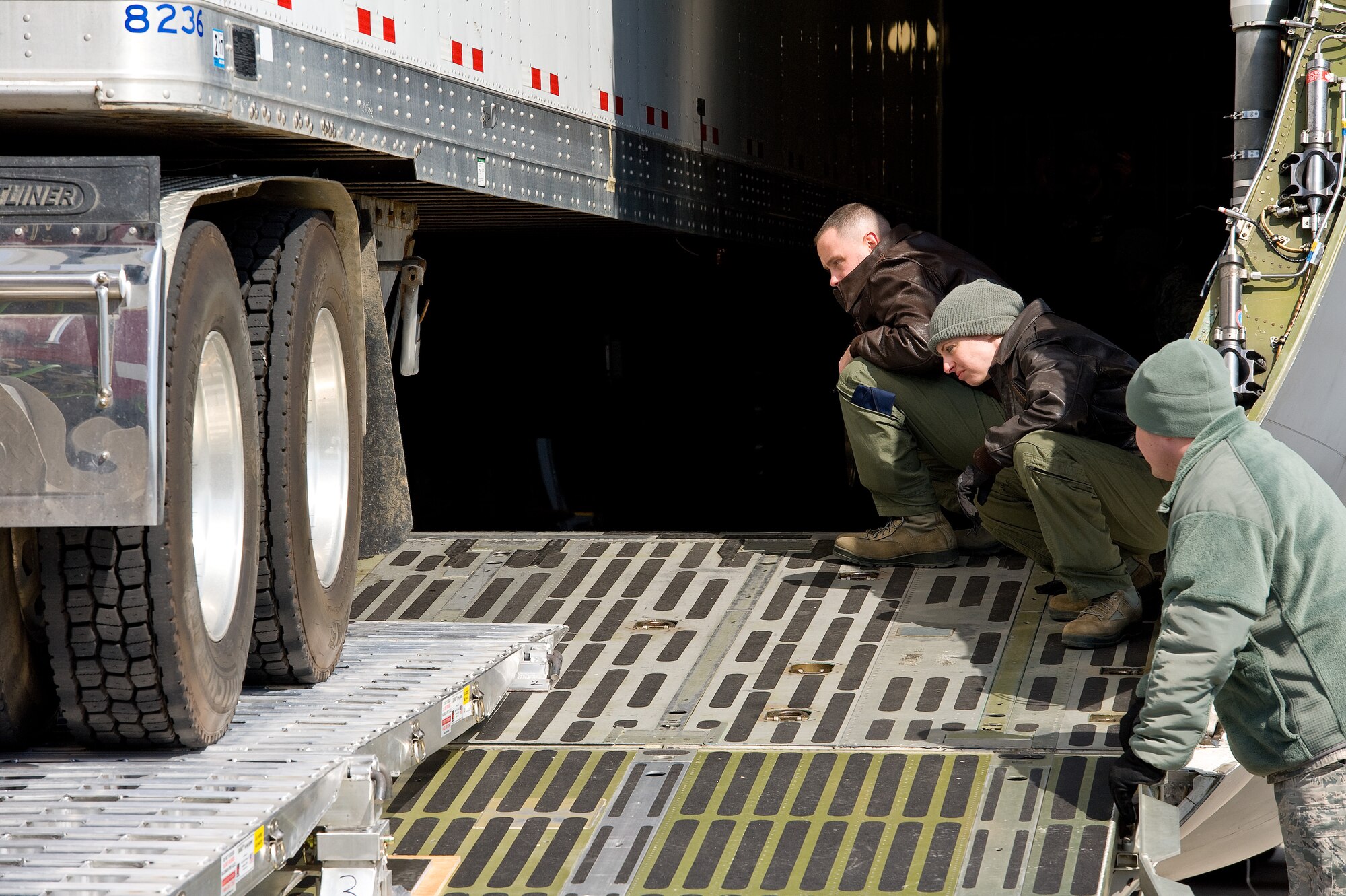 Tech. Sgt. Justin Leonard, left, and Senior Airman Kayla Russell, both 9th Airlift Squadron loadmasters, keep watch on the rear wheels of a Western Star Constellation truck as it rolls backwards up the DAMAS 26K loading ramp into the cargo compartment of a C-5M Super Galaxy March 3, 2016, on Dover Air Force Base, Del. The new loading ramp system known as DAMAS 26K which stands for DOMOPS Airlift Modular Approach Shoring, can be set up by two or three individuals in 14 minutes and was used in this annual training requirement to validate its use by updating the Air Transportability Test Loading Activity certification. This made it approved for use on military aircraft. (U.S. Air Force photo/Roland Balik)