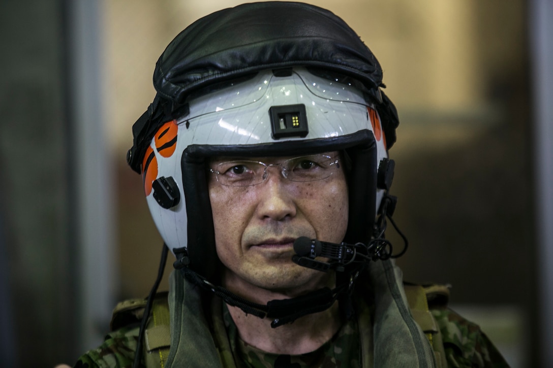 Maj. Gen. Hideki Agario before a flight on a MV-22B Osprey during a visit to Marine Corps Air Station Futenma, Okinawa, Japan, March 8, 2016. Agario, along with other Japan Ground Self-Defense Force service members, visited MCAS Futenma to have a closer look at the Osprey and experience its capabilities firsthand. Agario is the commanding general of 15th Brigade, JGSDF, located in Naha, Okinawa. The aircraft flown are with Marine Medium Tiltrotor Squadron 262, Marine Aircraft Group 36, 1st Marine Aircraft Wing, III Marine Expeditionary Force. (U.S. Marine Corps photo by Cpl. William Hester/ Released)