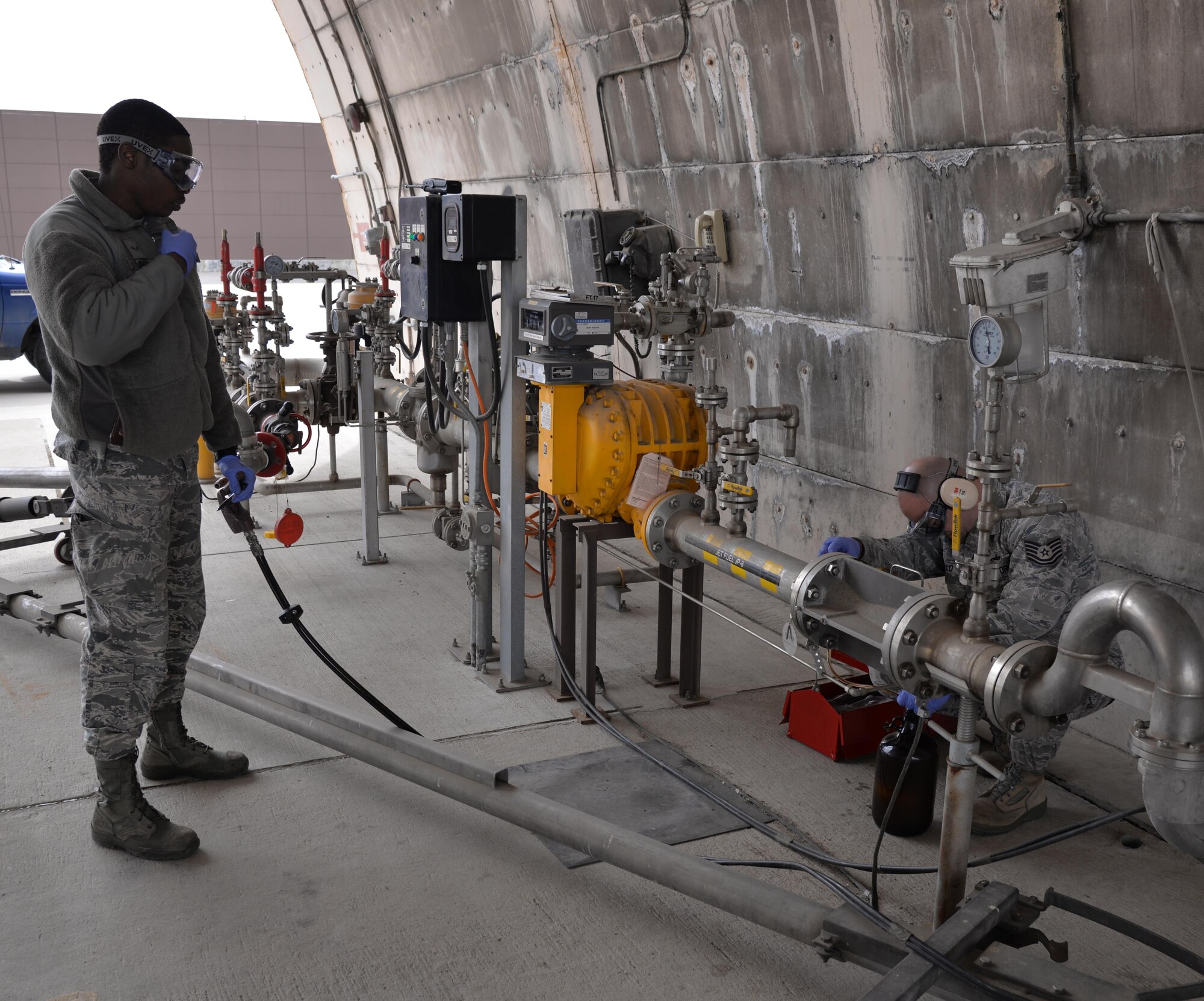 Airman 1st Class Kevin Linton, 51st Logistics Readiness Squadron laboratory technician, and Tech. Sgt. Jason Bello, 51st LRS fuels laboratory NCO in charge, perform real-world fuel testing March 8, 2016, at Osan Air Base, Republic of Korea. During readiness exercise Beverly Midnight 16-01, members from the petroleum, oils and lubricants section pull double duty by meeting both real-world and exercise mission requirements. (U.S. Air Force photo by Staff Sgt. Benjamin Sutton/Released) 