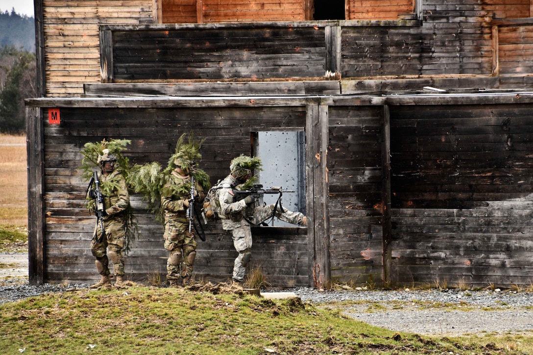 Army Spc. Ben Sherman, right, prepares to enter a building through a window as members of his team provide security during a live-fire exercise at Grafenwoehr Training Area, Germany, Feb. 24, 2016. Sherman is a cavalry scout assigned to the 4th Squadron, 2nd Cavalry Regiment. Army photo by Sgt. William A. Tanner