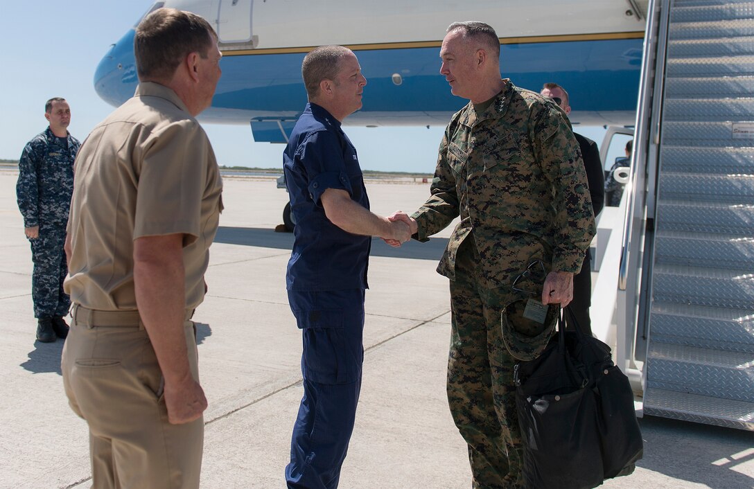 Marine Corps Gen. Joseph F. Dunford Jr., right, chairman of the Joint Chiefs of Staff, exchanges greetings with Coast Guard Rear Adm. Chris Tomney, director of Joint Interagency Task Force South, at Naval Air Station Key West, Fla., March 8, 2016. The task force conducts interagency and international detection and monitoring operations, and facilitates the interdiction of illicit trafficking and other narcoterrorist threats to support national and partner nation security. DoD photo by Navy Petty Officer 2nd Class Dominique A. Pineiro