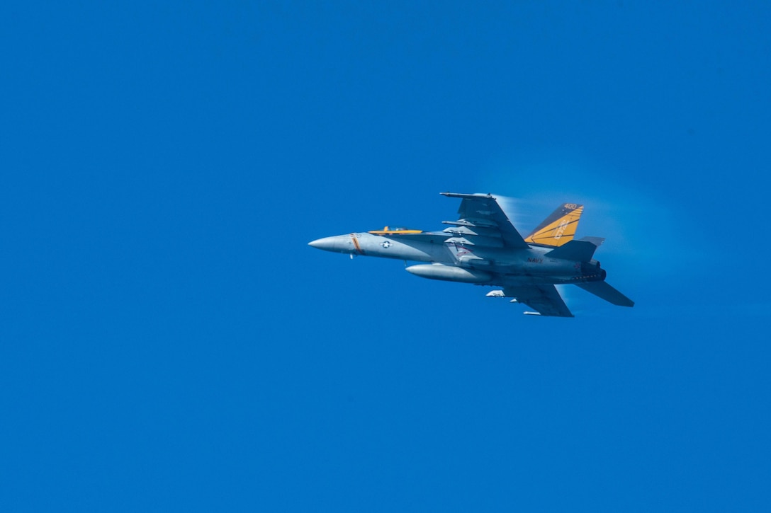 An F/A-18E Super Hornet assigned to the Vigilantes of Strike Fighter Squadron 151 flies over the aircraft carrier USS John C. Stennis during an airpower demonstration in the Philippine Sea, March 7, 2016. Navy photo by Petty Officer 3rd Class Kenneth Rodriguez Santiago