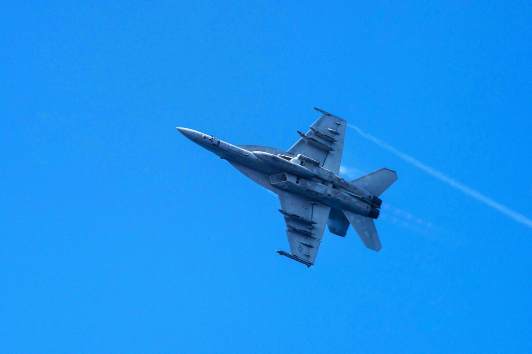 An F/A-18E Super Hornet assigned to the Tophatters of Strike Fighter Squadron 14 flies over the aircraft carrier USS John C. Stennis during an airpower demonstration in the Philippine Sea, March 7, 2016. Navy photo by Petty Officer 3rd Class Kenneth Rodriguez Santiago