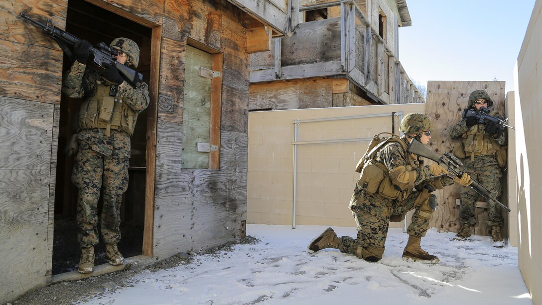 U.S. Marines assigned to Detachment Military Police Company D, 4th Law Enforcement Battalion, assault and clear a complex during military operations on urban terrain training at Joint Base Elmendorf-Richardson, Alaska, March 6, 2016. The MOUT training prepared the Marines for their upcoming deployment to Serbia where they will serve as military police advisors. (U.S. Air Force photo/Alejandro Pena)