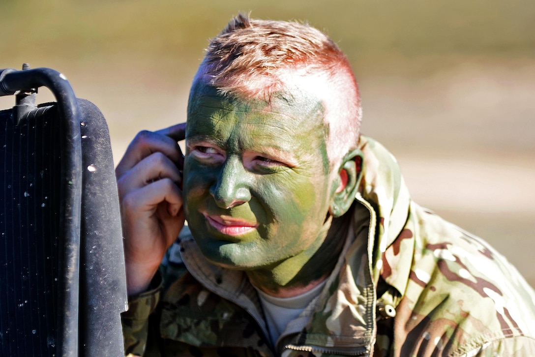 Capt. Andy Jenks, an Army chaplain, paints his face in camouflage during Exercise Sky Soldier 16 on Chinchilla training area in Albacete, Spain, March 4, 2016. Jenks is assigned to the 1st Battalion, 503rd Infantry Regiment, 173rd Airborne Brigade. Army photo by Staff Sgt. Opal Vaughn