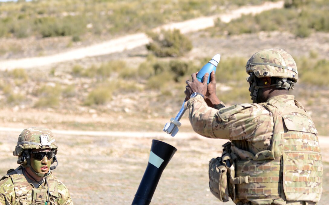 Army Sgt. Scott Dario, left, observes as Army Pvt. Bryan Philip loads a 81 mm round into an M252 mortar during Exercise Sky Soldier 16 on Chinchilla training area in Albacete, Spain, March 4, 2016. Dario and Philip are mortarmen assigned to the 1st Battalion, 503rd Infantry Regiment, 173rd Airborne Brigade. Army photo by Staff Sgt. Opal Vaughn