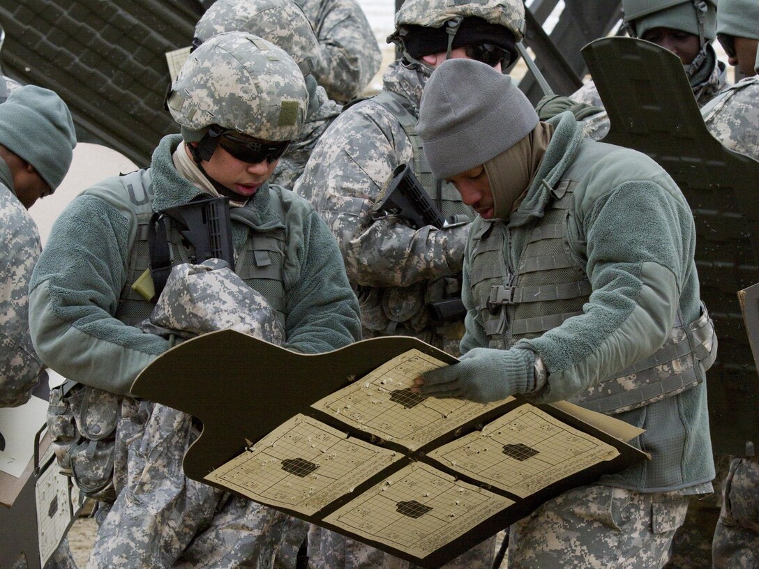 A U.S. Army Reserve range cadre within the 200th Military Police Command scores a soldier's target during a qualification range at Joint Base McGuire-Dix-Lakehurst March 4. (U.S. Army photo by Sgt. Jennifer Spiker)