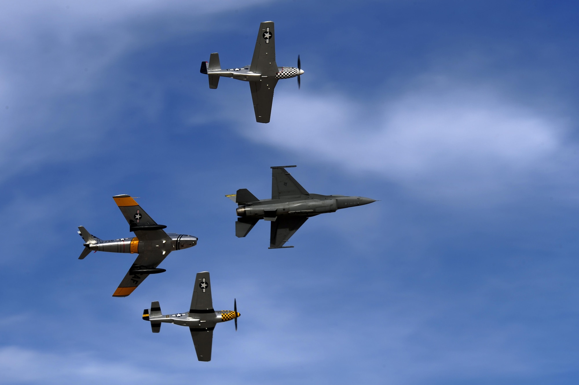 An F-86 Sabre, P-51 Mustang, TF-51 and F-16 Fighting Falcon fly in formation during the 2016 Heritage Flight Training and Certification Course at Davis-Monthan Air Force Base, Ariz., March 5, 2016. During the course, aircrews practice ground and flight training to enable civilian pilots of historic military aircraft and U.S. Air Force pilots of current fighter aircraft to fly safely in formations together. (U.S. Air Force photo by Senior Airman Chris Drzazgowski/Released)