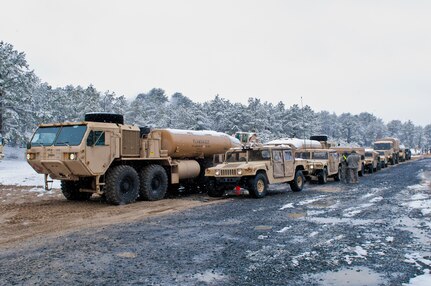 Heavy Expanded Mobility Tactical Trucks, of the 957th Quartermaster Company (Petroleum Supply), stand by for the fueling of vehicles during Combat Support Training Exercise 78-16-01 at Joint Base McGuire-Dix-Lakehurst, N.J., March 04, 2016. CSTX 78-16-01 is a U.S. Army Reserve exercise conducted at multiple locations across the country designed to challenge combat support units and Soldiers to improve and sustain skills necessary during a deployment. (U.S. Army photo by Staff Sgt. Dalton Smith/Released)