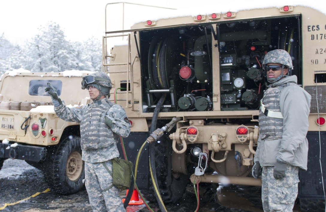 Spc. Alexander Medina (left) and Spc. Phillip Ayers (right), of the 957th Quartermaster Company (Petroleum Supply), wave on-coming Humvees to their fuel point during Combat Support Training Exercise 78-16-01 at Joint Base McGuire-Dix-Lakehurst, N.J., March 04, 2016. CSTX 78-16-01 is a U.S. Army Reserve exercise conducted at multiple locations across the country designed to challenge combat support units and Soldiers to improve and sustain skills necessary during a deployment. (U.S. Army photo by Staff Sgt. Dalton Smith/Released)