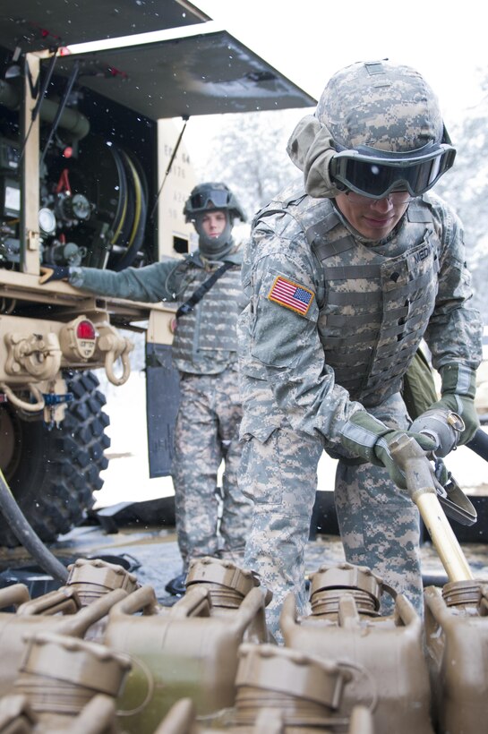 Spc. Alexander Medina, a Soldier with the 957th Quartermaster Company (Petroleum Supply), fills cans with diesel fuel during Combat Support Training Exercise 78-16-01 at Joint Base McGuire-Dix-Lakehurst, N.J., March 4, 2016. CSTX 78-16-01 is a U.S. Army Reserve exercise conducted at multiple locations across the country designed to challenge combat support units and Soldiers to improve and sustain skills necessary during a deployment. (U.S. Army photo by Staff Sgt. Dalton Smith/Released)