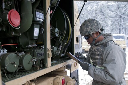Spc. Phillip Ayers, a Soldier with the 957th Quartermaster Company (Petroleum Supply), writes the amount of diesel fuel being used to fill vehicles during Combat Support Training Exercise 78-16-01 at Joint Base McGuire-Dix-Lakehurst, N.J., March 04, 2016. CSTX 78-16-01 is a U.S. Army Reserve exercise conducted at multiple locations across the country designed to challenge combat support units and Soldiers to improve and sustain skills necessary during a deployment. (U.S. Army photo by Staff Sgt. Dalton Smith/Released)