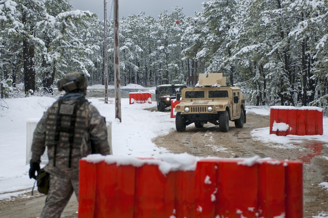 Humvees approach the Entry Control Point of the 157th Combat Support Sustainment Battalion during Combat Support Training Exercise 78-16-01 at Joint Base McGuire-Dix-Lakehurst, N.J., March 4, 2016. CSTX 78-16-01 is a U.S. Army Reserve exercise conducted at multiple locations across the country designed to challenge combat support units and Soldiers to improve and sustain skills necessary during a deployment. (U.S. Army photo by Staff Sgt. Dalton Smith/Released)