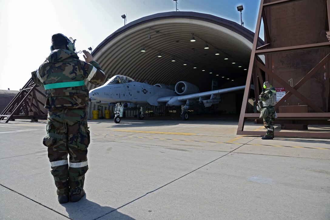 Staff Sgt. Joshua Heath, 25th Aircraft Maintenance Unit crew chief, marshals an A-10 Thunderbolt II during exercise Beverly Midnight 16-01 at Osan Air Base, Republic of Korea, March 9, 2016. The jet was part of the first series of A-10s to take off during BM 16-01, an exercise designed to test the warfighting capabilities of the units assigned to the 51st Fighter Wing with a focus on readiness, defending the base and executing flying operations.  (U.S. Air Force photo by Tech. Sgt. Travis Edwards/Released)