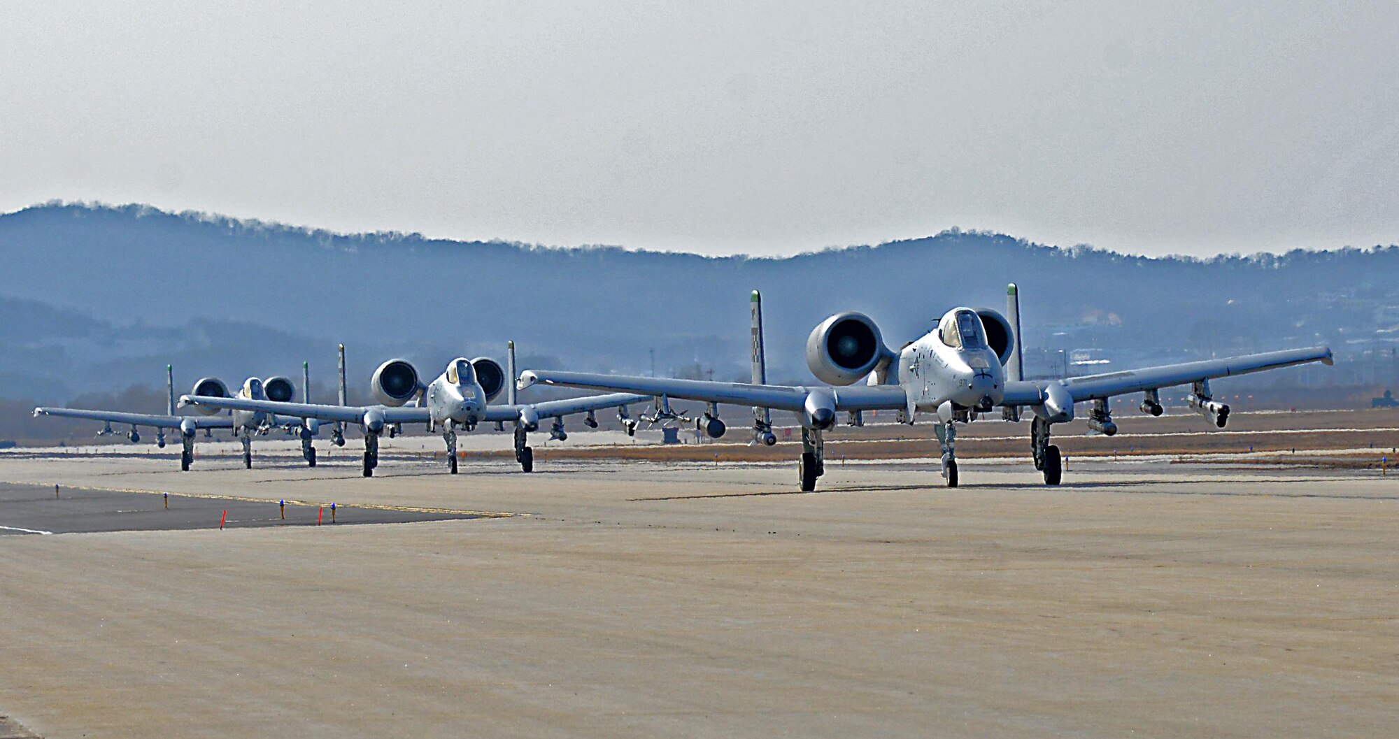 Three A-10 Thunderbolt IIs move down the flightline to position for takeoff during exercise Beverly Midnight 16-01 at Osan Air Base, Republic of Korea, March 9, 2016. These were the first A-10s to take off during BM 16-01, an exercise designed to test the warfighting capabilities of the units assigned to the 51st Fighter Wing with a focus on readiness, defending the base and executing flying operations.   (U.S. Air Force photo by Tech. Sgt. Travis Edwards/Released)