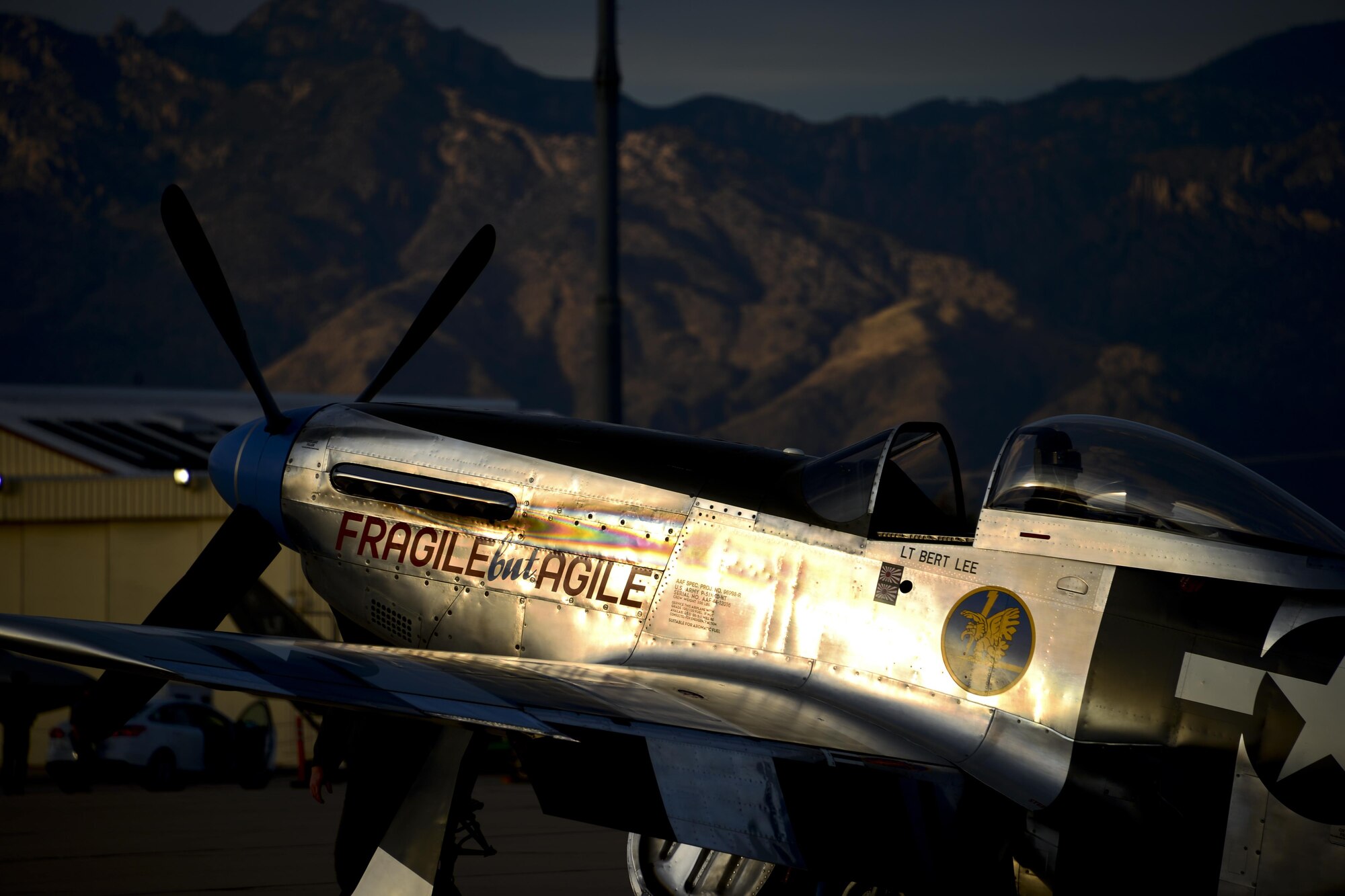 The P-51 Mustang “Fragile but Agile” sits on the flightline after the first day of the 2016 Heritage Flight Training and Certification Course at Davis-Monthan Air Force Base, Ariz., March 4, 2016. During the course, aircrews practice ground and flight training to enable civilian pilots of historic military aircraft and U.S. Air Force pilots of current fighter aircraft to fly safely in formations together. (U.S. Air Force photo by Senior Airman Chris Drzazgowski/Released)