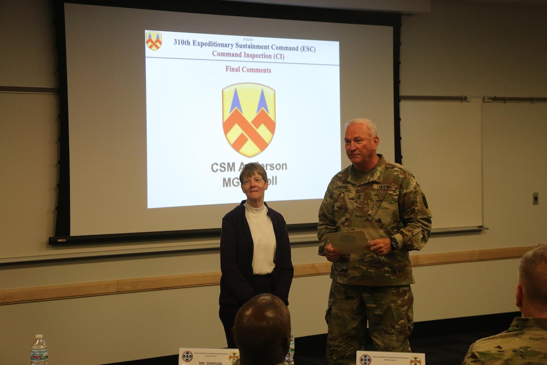 Maj. Gen. Leslie Carroll (right), the commanding general for the 377th Theater Sustainment Command presents a length of service certificate and emblem to Margaret “Peggy” Ranschaert in honor of her 45-year career of service as an Army civilian employee during a length of service ceremony held March 4 at the Spc. Luke P. Frist Army Reserve Center at Fort Benjamin Harrison, Ind.
