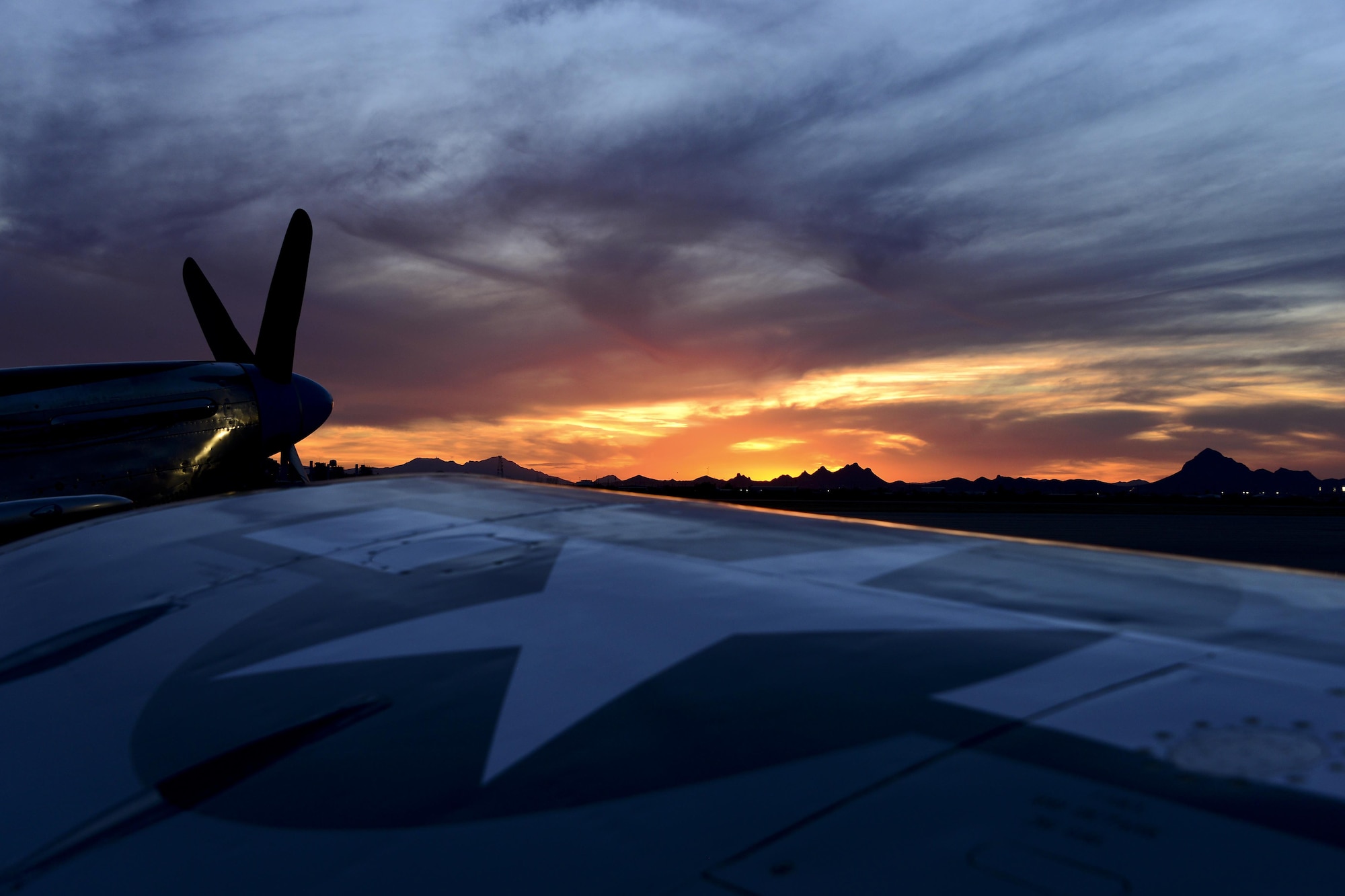 The sun sets on the flightline after the first day of the 2016 Heritage Flight Training and Certification Course at Davis-Monthan Air Force Base, Ariz., March 4, 2016. Established in 1997, the HFTCC certifies civilian pilots of historic military aircraft and U.S. Air Force pilots to fly in formation together during the upcoming air show season. (U.S. Air Force photo by Senior Airman Chris Drzazgowski/Released)