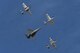 A TF-51 Mustang, Two P-51 Mustangs, and an F-16D Fighting Falcon fly in formation during the 2016 Heritage Flight Training and Certification Course at Davis-Monthan Air Force Base, Ariz., March 4, 2016. The annual aerial demonstration training event has been held at D-M since 2001, the course featured aerial demonstrations from historical and modern fighter aircraft. (U.S. Air Force photo by Senior Airman Chris Drzazgowski/Released)