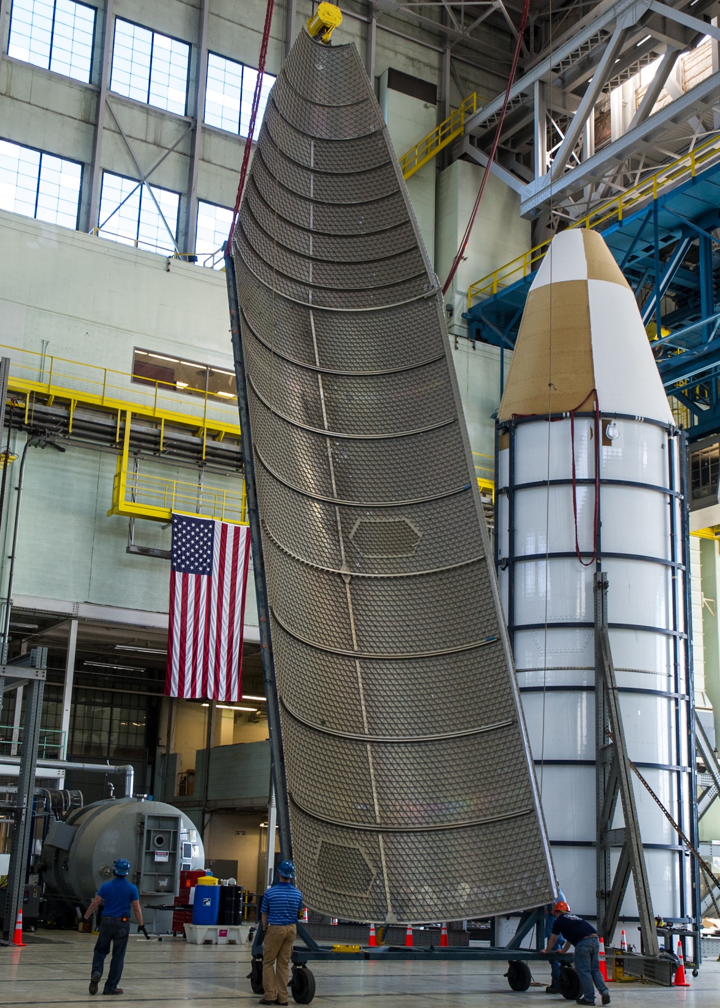 DAYTON, Ohio - Air Force Research Laboratory engineers and technicians from the Structural Validation Branch of the Aerospace Vehicles Division, Aerospace Systems Directorate, partnered with museum restoration crews to assemble a 60 foot tall payload fairing from the Titan IVB space launch vehicle between  Feb. 29-March 2, 2016. The impressive Titan IVB, with roots going back to the early days of U.S. Air Force and civil space launch, is significant as the museum looks to share the story of USAF and USAF-enabled space operations in its Space Gallery. The Titan IVB will be on display in the new fourth building at the National Museum of the U.S. Air Force which opens to the public on June 8. (U.S. Air Force photo by Ken LaRock)