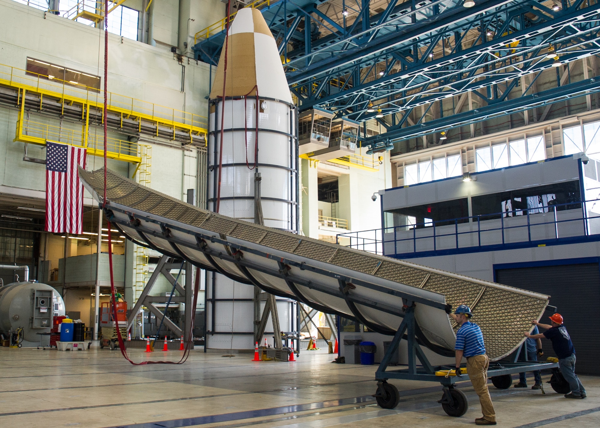 DAYTON, Ohio - Air Force Research Laboratory engineers and technicians from the Structural Validation Branch of the Aerospace Vehicles Division, Aerospace Systems Directorate, partnered with museum restoration crews to assemble a 60 foot tall payload fairing from the Titan IVB space launch vehicle between  Feb. 29-March 2, 2016. The impressive Titan IVB, with roots going back to the early days of U.S. Air Force and civil space launch, is significant as the museum looks to share the story of USAF and USAF-enabled space operations in its Space Gallery. The Titan IVB will be on display in the new fourth building at the National Museum of the U.S. Air Force which opens to the public on June 8. (U.S. Air Force photo by Ken LaRock)