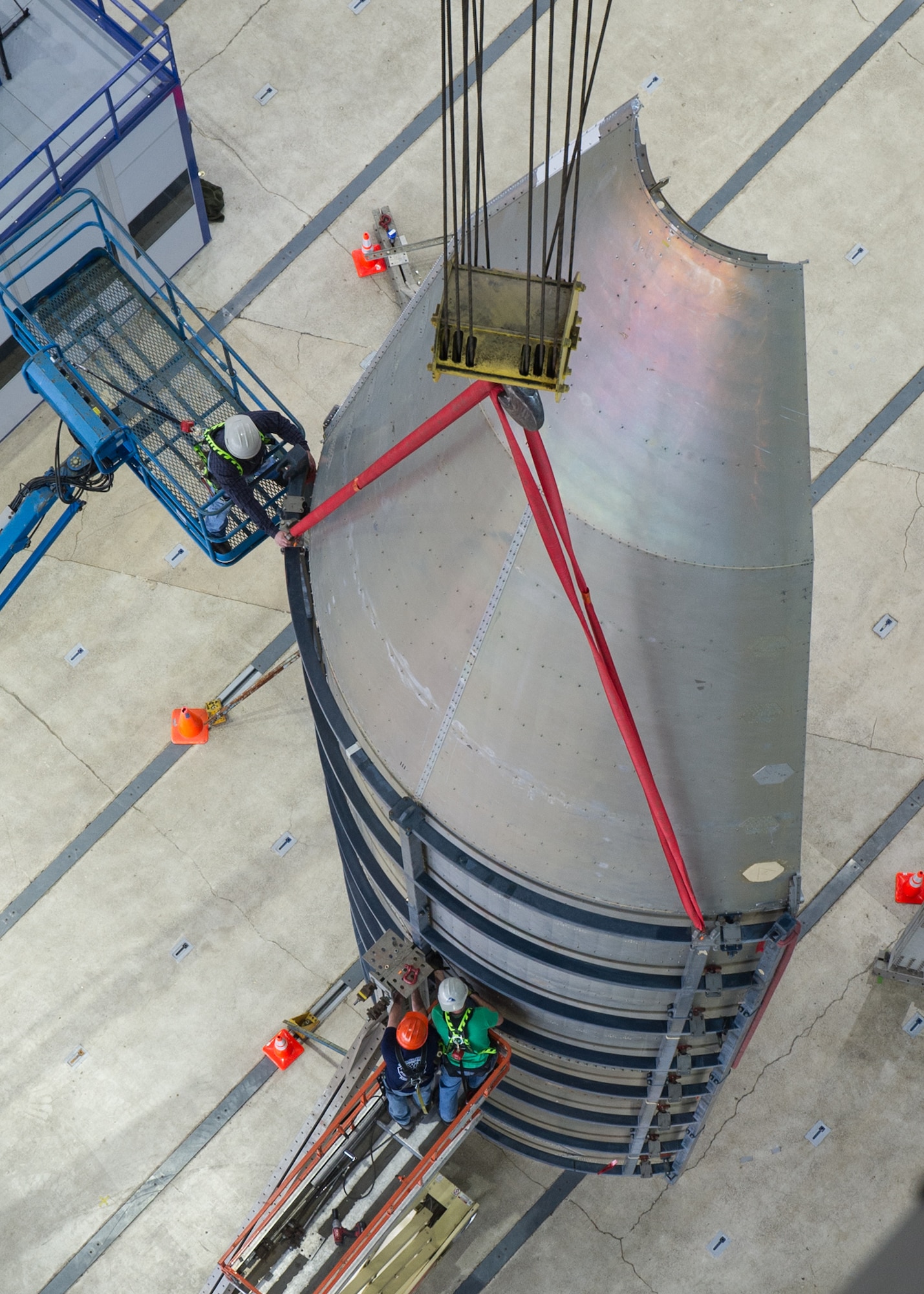 DAYTON, Ohio - Air Force Research Laboratory engineers and technicians from the Structural Validation Branch of the Aerospace Vehicles Division, Aerospace Systems Directorate, partnered with museum restoration crews to assemble a 60 foot tall payload fairing from the Titan IVB space launch vehicle between  Feb. 29-March 2, 2016. The impressive Titan IVB, with roots going back to the early days of U.S. Air Force and civil space launch, is significant as the museum looks to share the story of USAF and USAF-enabled space operations in its Space Gallery. The Titan IVB will be on display in the new fourth building at the National Museum of the U.S. Air Force which opens to the public on June 8. (U.S. Air Force photo by Ken LaRock)