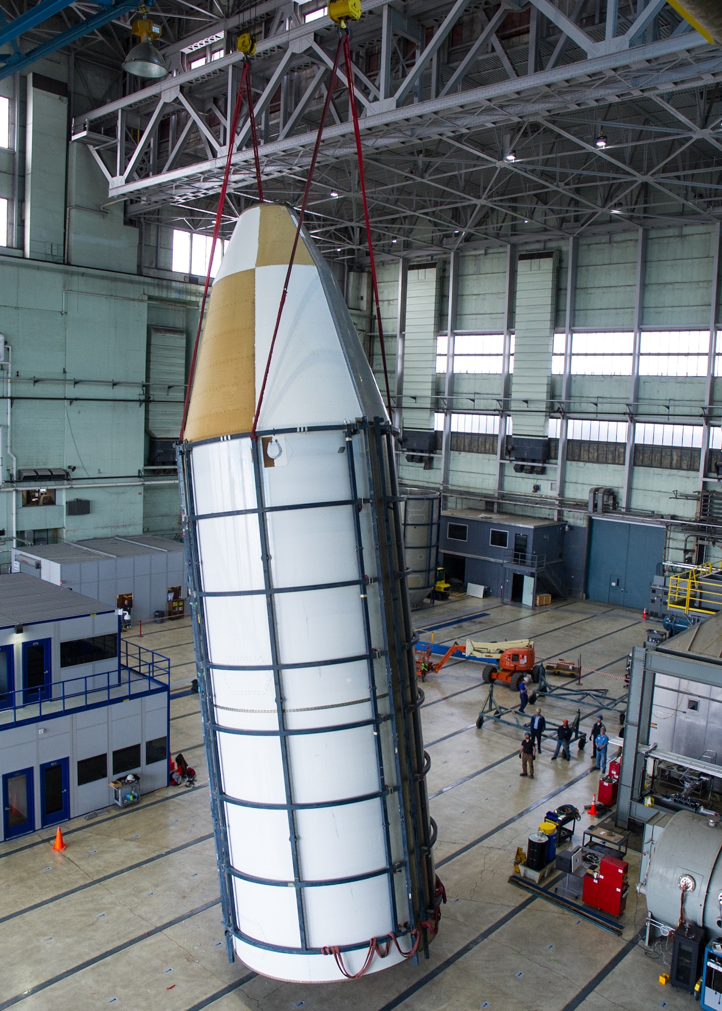 DAYTON, Ohio - Air Force Research Laboratory engineers and technicians from the Structural Validation Branch of the Aerospace Vehicles Division, Aerospace Systems Directorate, partnered with museum restoration crews to assemble a 60 foot tall payload fairing from the Titan IVB space launch vehicle between  Feb. 29-March 2, 2016. The impressive Titan IVB, with roots going back to the early days of U.S. Air Force and civil space launch, is significant as the museum looks to share the story of USAF and USAF-enabled space operations in its Space Gallery. The Titan IVB will be on display in the new fourth building at the National Museum of the U.S. Air Force which opens to the public on June 8. (U.S. Air Force photo by Ken LaRock)