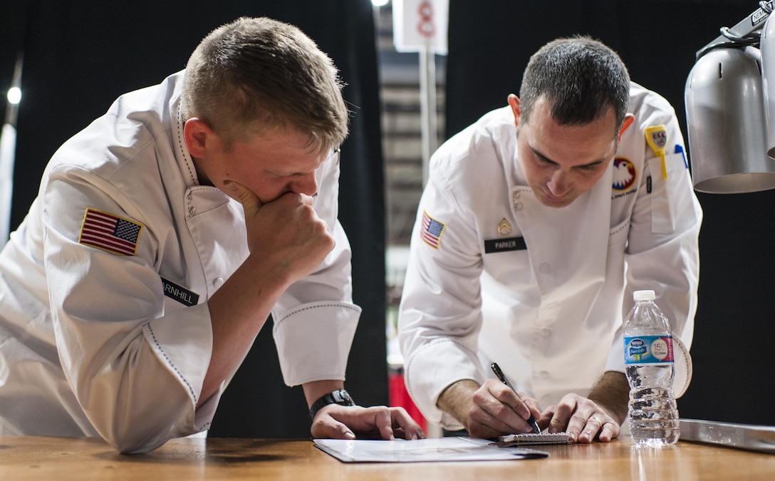 U.S. Army Reserve Culinary Arts Team members, Sgt. Joshua Barnhill, left, with the 377th Theater Sustainment Command, and Staff Sgt. Joseph Parker, with the 451st Quartermaster Company, 143rd Sustainment Command (Expeditionary), put the finishing touches on the cooking plan during the Nutritional Hot Food Challenge category at the 41st Annual Military Culinary Arts Competitive Training Event, March 8, 2016, at Fort Lee, Va.Parker and Barnhill earned a silver in the category with their roasted beet salad, pan-seared trout, and eggless, milkless spice cake, all coming in at under 850 calories. (U.S. Army photo by Timothy L. Hale) (Released)