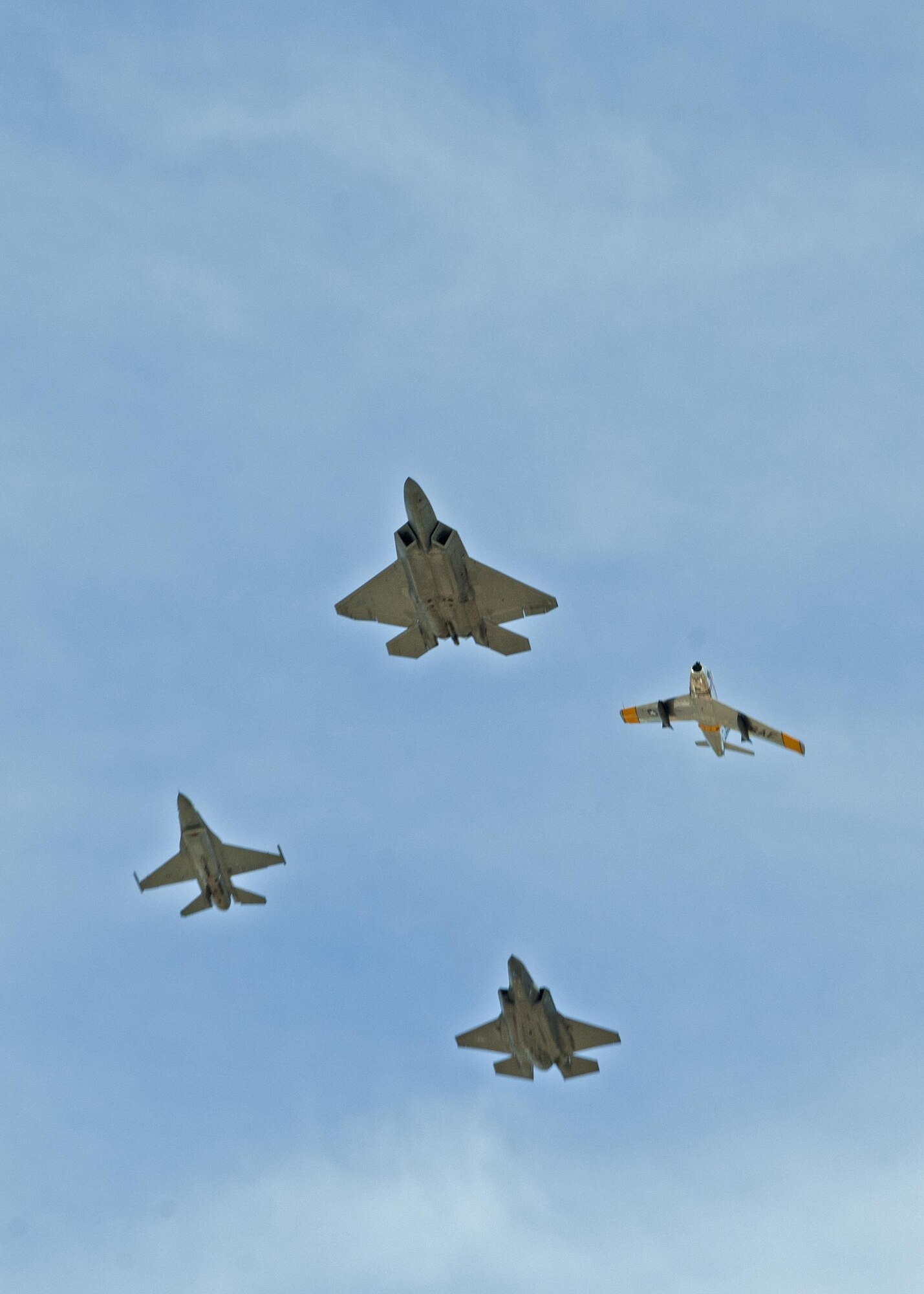 U.S. Air Force F-16 Fighting Falcon, F-22 Raptor, F-86 Sabre and a F-35 Lightning II fly in formation during the 2016 Heritage Flight Training and Certification Course at Davis-Monthan Air force Base, Ariz., March 6, 2016. The annual aerial demonstration training event has been held at D-M since 2001. The aircraft that participated in this year’s HFTCC were the F-35 Lightning II, the F-22 Raptor and the F-16 Fighting Falcon. The historic aircraft included the P-51 Mustang, the P-40 Warhawk, the P-38 Lightning, the P-47 Thunderbolt and the F-86 Sabre. (U.S. Air Force photo by Senior Airman Camilla Elizeu/Released)