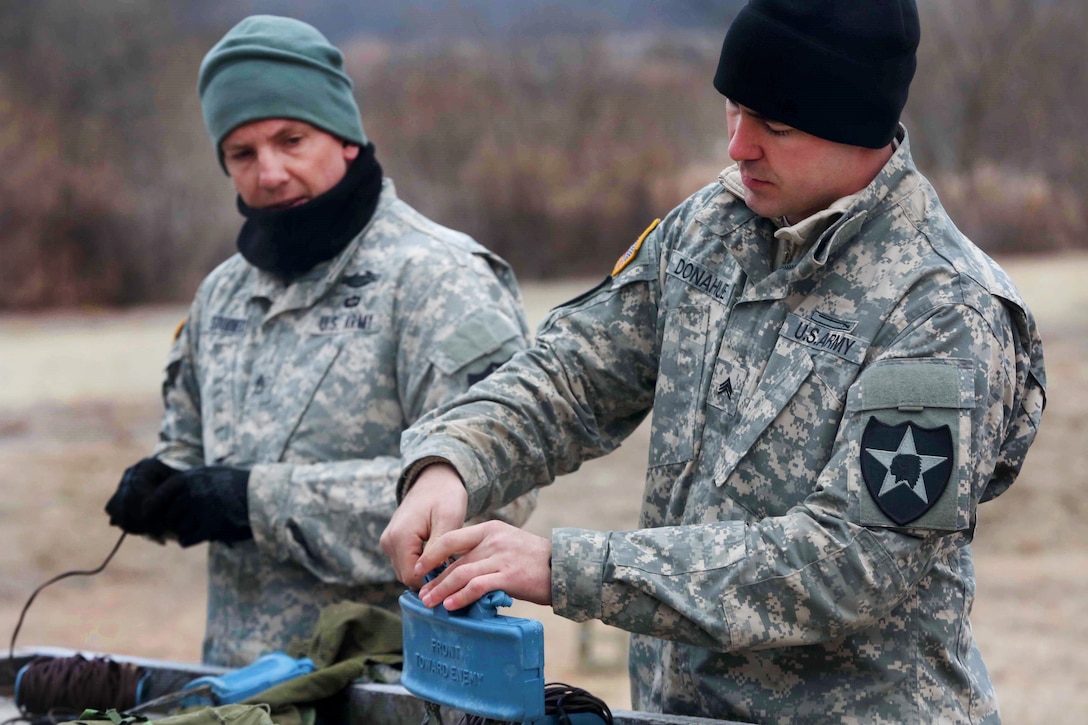 Army Staff Sgt. Timothy Stodieck, left, and Army Sgt. Jodie Donahue review how to set up an M18A1 Claymore mine at California Range, South Korea, March 2, 2016. Stodieck and Donahue are assigned to Company B, 2nd Battalion, 3rd Infantry Regiment, 2nd Stryker Brigade Combat Team. The soldiers participated in Operation Pacific Pathways, which strengthens strategic partnerships to support continued regional stability. Army photo by Pfc. Elliott Page