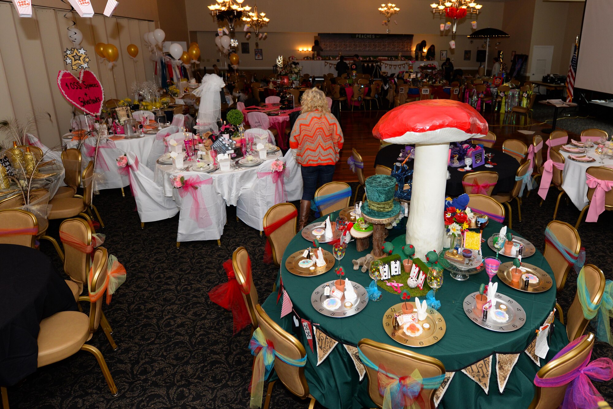 Members set up for the Spouses Dining-in, March 5, 2016, at Seymour Johnson Air Force Base, North Carolina.  Each squadron decorated their table in an assigned movie theme, spouses dressed to match their table’s theme. (U.S. photo/Airman 1st Class Ashley Williamson)