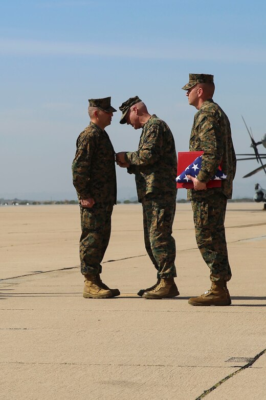 Sgt. Maj. Richard Charron, former sergeant major of Marine Corps Air Station Miramar, receives the Legion of Merit during his relief and appointment ceremony aboard MCAS Miramar, Calif., March 2. Charron relinquished his duties to Sgt. Maj. Michael Walton, former sergeant major of Marine Fighter Attack Squadron 232. (U.S. Marine Corps photo by Cpl. Alissa Schuning/Released)