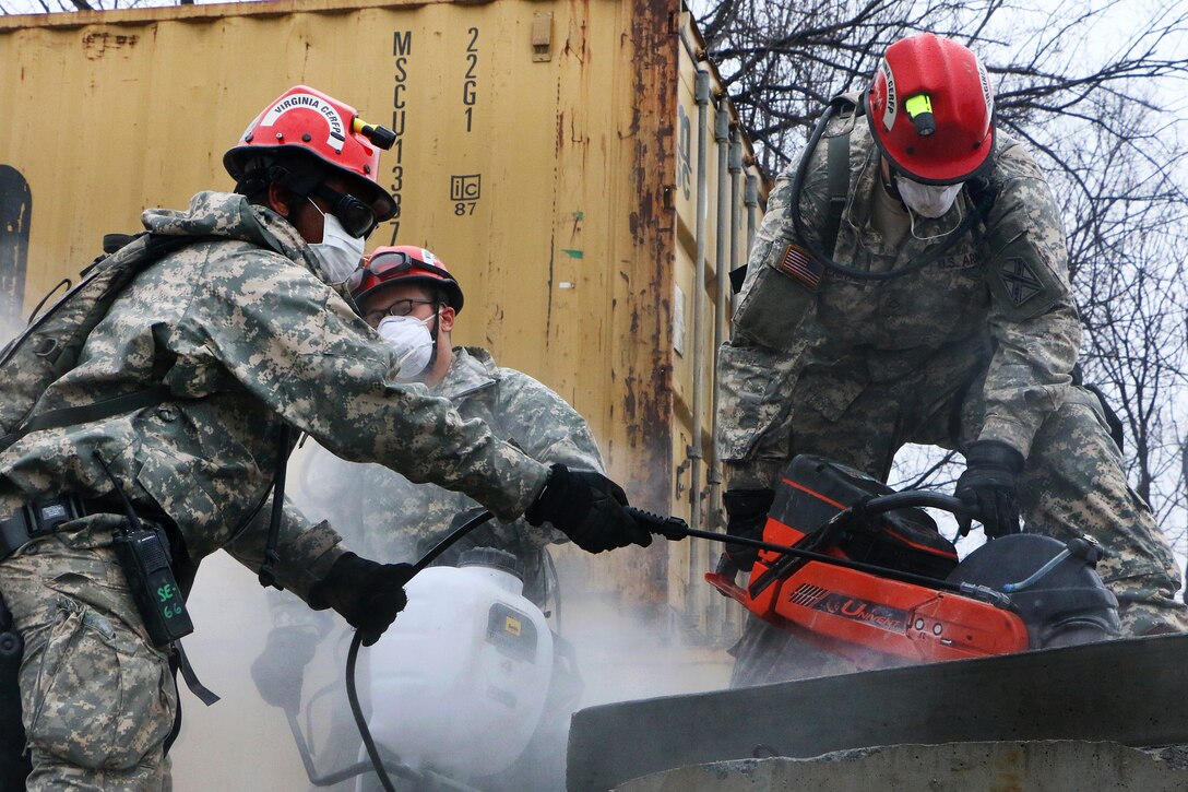 Virginia National Guardsmen use a high-powered cutting tool to search for simulated survivors while participating in Sovereign Guardian 2016 with members of the District of Columbia Fire and Emergency Medical Service Department at the Washington Fire and EMS Training Academy in Wash., D.C., Feb. 24, 2016. The guardsmen are assigned to the Virginia National Guard’s Chemical, Biological, Radiological, Nuclear, High Yield Explosive Enhanced Response Force Package. Virginia National Guard photo by Alfred Puryear