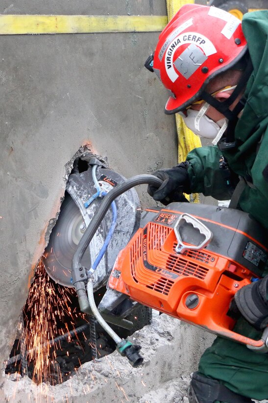 A Virginia National Guardsman use a high-powered cutting tool to cut through a concrete block searching for simulated survivors during the Sovereign Guardian 2016 exercise at the Washington Fire and EMS Training Academy in Wash., D.C., Feb. 24, 2016. Virginia National Guard photo by Alfred Puryear