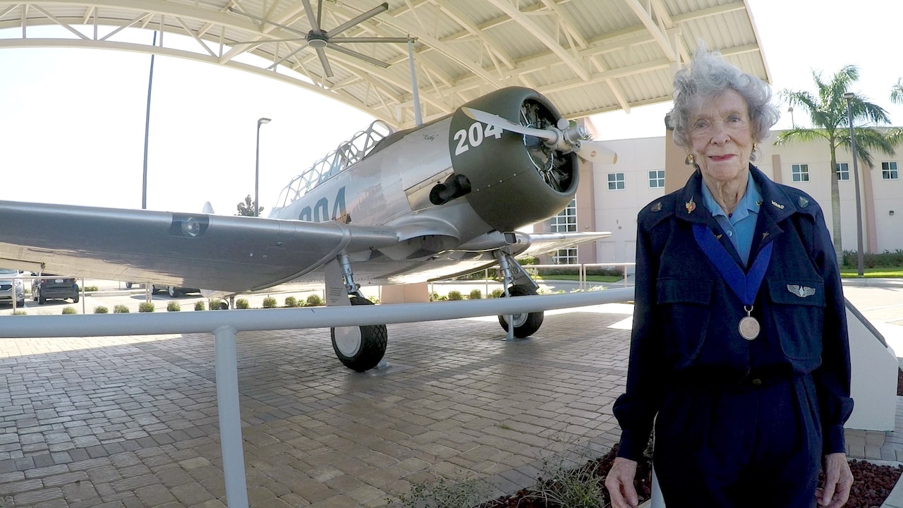 Bernice Haydu, a Women Airforce Service Pilot, or WASP, during World War II, stands next to an AT-6 Texan at Page Field near Fort Myers, Florida, Feb. 20, 2016. The WASPs flew Texans during flight training at Avenger Field in Sweetwater, Texas. DoD photo by Navy Petty Officer 2nd Class Glenn Slaughter