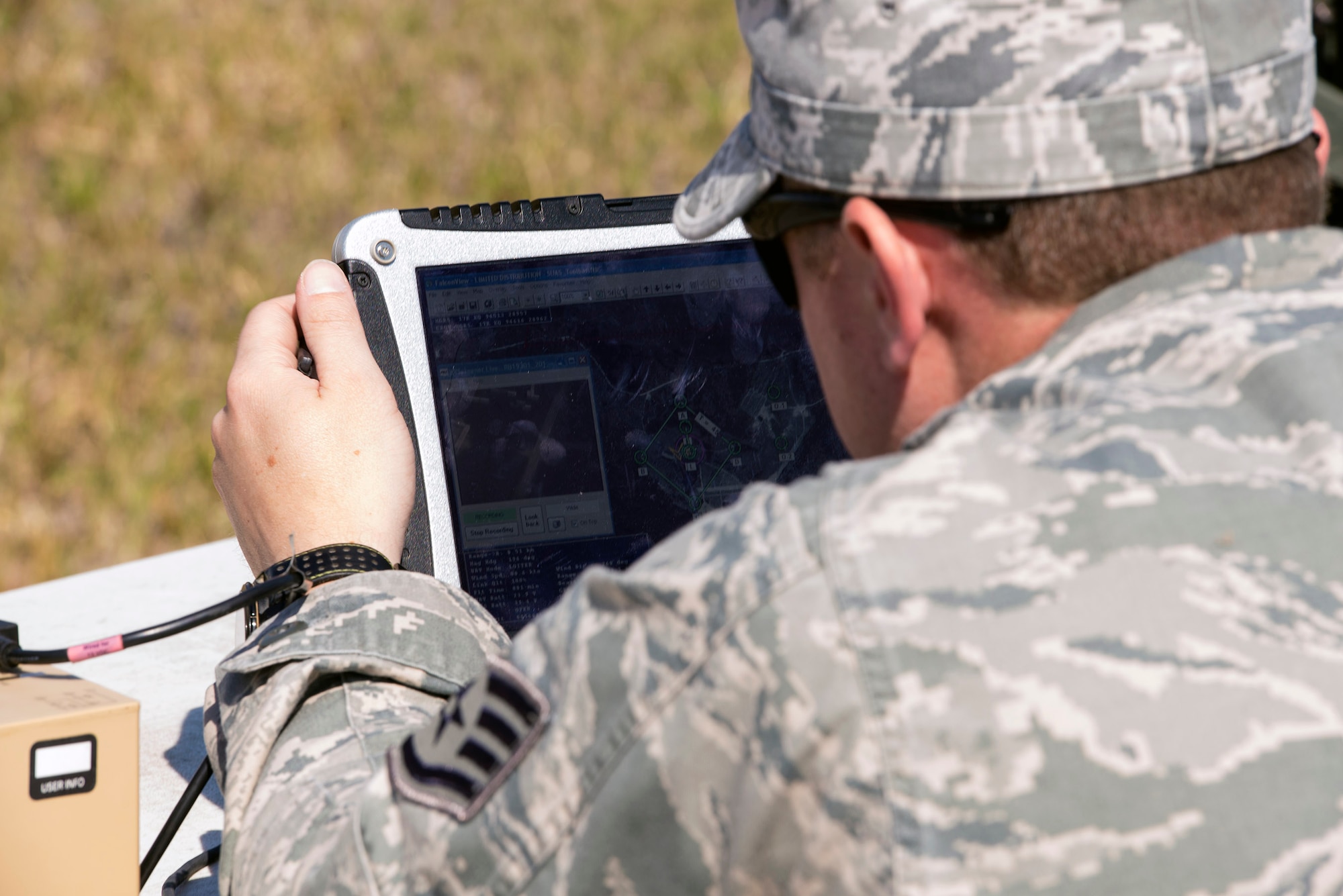 U.S. Air Force Staff Sgt. Nicolas Sellers, 823d Base Defense Squadron RQ-11 B Raven small unmanned aircraft system operator, views flight movements during a mission capabilities demonstration, March 3, 2016, at Moody Air Force Base, Ga. Sellers is one of approximately 50 Raven operators within the 820th Base Defense Group. (U.S. Air Force photo by Airman 1st Class Greg Nash/Released)