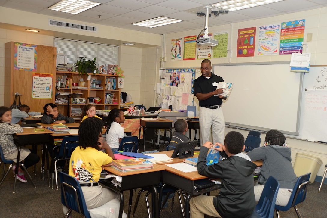 Lt. Col. Nathaniel Robinson, executive officer, Marine Corps Logistics Base Albany, reads to attentive 3rd graders at Radium Springs Elementary School, Albany, Ga., during the Read Across America initiative, recently. The annual event is held to celebrate the birthday of author/cartoonist, Dr. Seuss.
