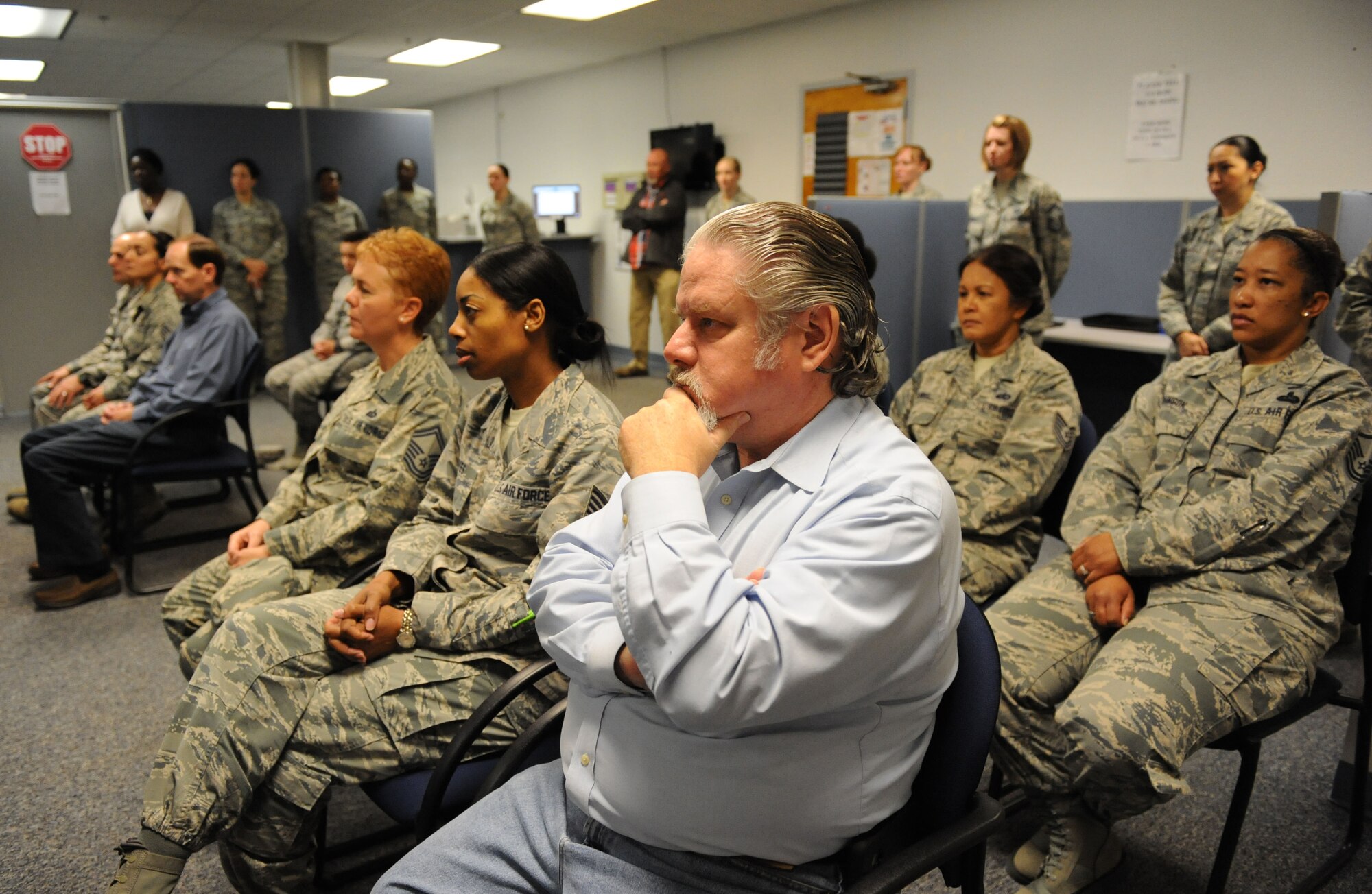 James Taylor, 81st Force Support Squadron readiness plans and mortuary affairs chief, sits among Keesler personnel during an Integrated Personnel Management Initiative (IPM-I) ribbon cutting ceremony at the Sablich Center, March 8, 2016, Keesler Air Force Base, Miss. The purpose of the 81st and 403rd Force Support Squadrons’ integration efforts at Keesler is to achieve a more capable and efficient organization to serve active duty and Reserve Airmen, their families and retirees who utilize FSS services. This effort was directed by the Secretary of the Air Force. (U.S. Air Force photo by Kemberly Groue)