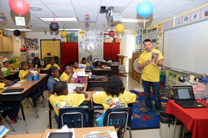 Capt. Jose Castillo, inspector-instructor, Detachment 2, Supply Company, Combat Logistics Battalion 453, 4th Marine Logistics Group, Marine Corps Logistics Base Albany, reads to 4th-grade students at International Studies Charter School, Albany, Ga., recently. The event was a part of the annual Read Across America activities, which celebrate the birthday of author, illustrator Theodor Seuss Geisel, better known as Dr. Seuss.
